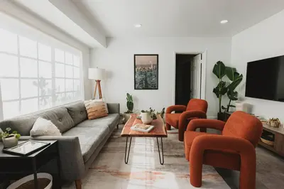 a living room with a couch and orange chairs at Miami Oasis - Unit A in Miami