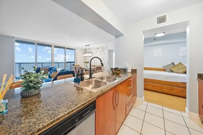 a kitchen with a sink and a living room with a bed at Oceanview Haven Spacious Inviting for 8 Guests in Miami