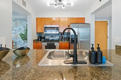 a kitchen counter with a sink with a faucet at Oceanview Haven Spacious Inviting for 8 Guests in Miami