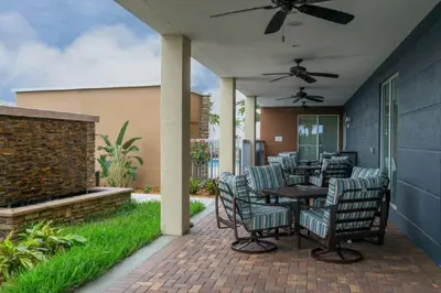 a patio with chairs and a table and a ceiling fan at Fairfield Inn & Suites by Marriott Fort Lauderdale Pembroke Pines in Pembroke Pines