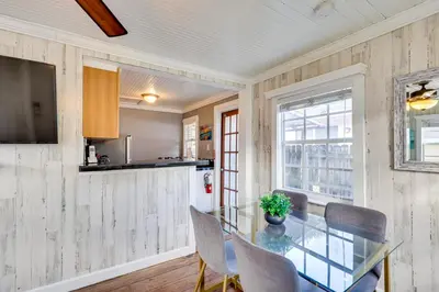 a dining room with a glass table and chairs at Shared Pool and Backyard Small and Cozy Guest House in Fort Lauderdale