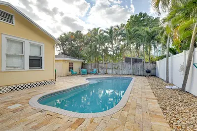 a swimming pool in the backyard of a house at Shared Pool and Backyard Small and Cozy Guest House in Fort Lauderdale
