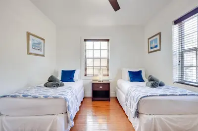 two beds in a room with blue pillows at House with Shared Pool Access 4 Mi to Beaches! in Fort Lauderdale