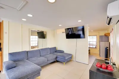 a living room with a couch and a flat screen tv at Detached Backyard Studio in Fort Lauderdale! in Fort Lauderdale