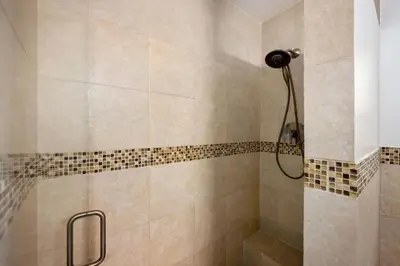 a bathroom with a shower with a shower head at Turtle Nest Bungalow in Fort Lauderdale