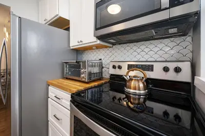 a kitchen with a stove and a tea kettle at Turtle Nest Bungalow in Fort Lauderdale