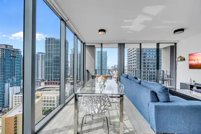 a living room with a blue couch and a glass table at Great 3 beds 3 baths Appartment Downtown Miami in Miami