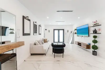 a living room with a couch and a chair at Prime Location 4BR Villa with Pool in Miami