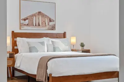 a bedroom with a large bed with white sheets at 921 Apartment 1 in Fort Lauderdale