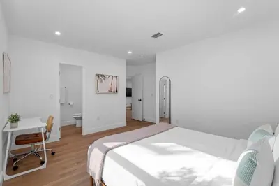 a white bedroom with a bed and a desk at 921 Apartment 2 in Fort Lauderdale