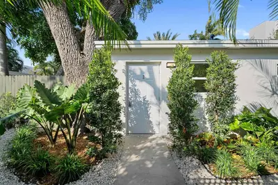a white garage with a door and some plants at 921 Apartment 2 in Fort Lauderdale