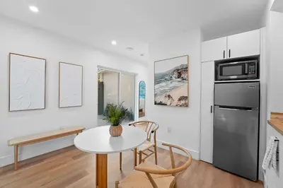 a kitchen with a table and a refrigerator at 921 Apartment 4 in Fort Lauderdale