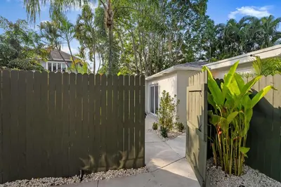 a fence with a gate in front of a house at 921 Apartment 4 in Fort Lauderdale