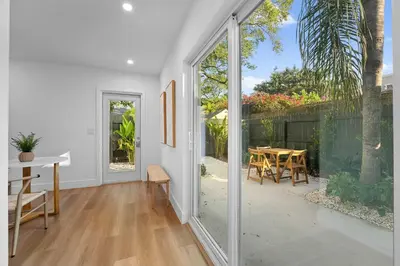 a white house with a patio with a table and chairs at 921 Apartment 4 in Fort Lauderdale