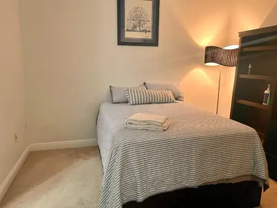 a bedroom with a bed with a striped blanket at Two private rooms with private bathroom in shared House in Fort Lauderdale