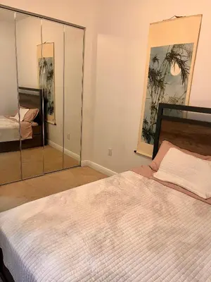 a bedroom with a large white bed and a mirror at Two private rooms with private bathroom in shared House in Fort Lauderdale