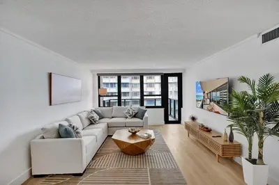 a living room with a couch and a table at Chic 2-Bedroom Condo with Beach Service & Gym / 1210 in Miami Beach
