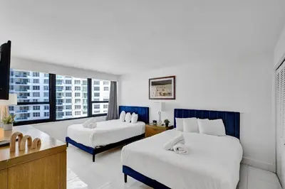 a hotel room with two beds and a large window at Ocean View Spacious 2 BDR Condo Beach Service 609 in Miami Beach