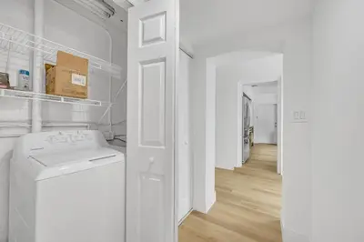 a white laundry room with a washing machine in it at POOL & BBQ with the family in Biscayne Park