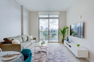 a living room with a couch and a large window at 3900-604LG DESIGN DISTRICT, CONDO 1 BEDROOM & 1 BATHROOM in Miami