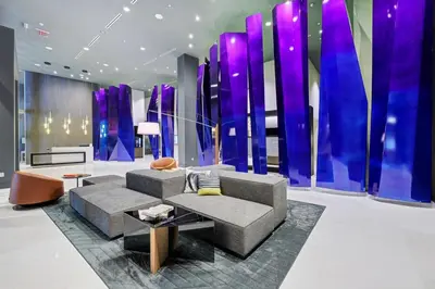 a living room with a couch and a purple wall at 3900-604LG DESIGN DISTRICT, CONDO 1 BEDROOM & 1 BATHROOM in Miami