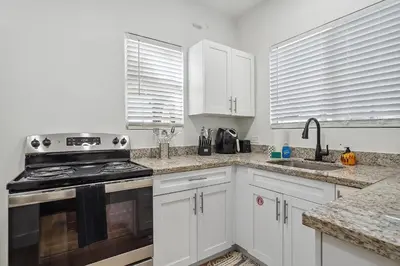a kitchen with white cabinets and a stove top oven at Casa Roselle 3 Bedrooms in Hollywood