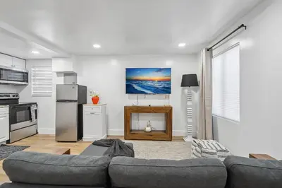 a living room with a couch and a tv at Casa Roselle 3 Bedrooms in Hollywood