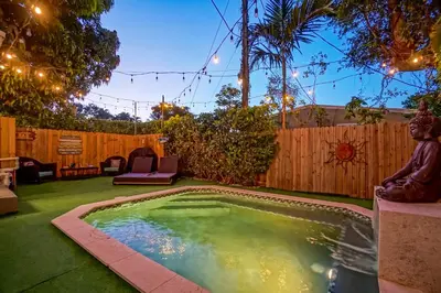 a small swimming pool in a backyard with a fence at Buddha House Pool Big Yard in Miami