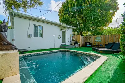 a swimming pool in the yard of a house at Buddha House Pool Big Yard in Miami