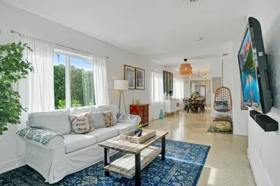 a living room with a white couch and a tv at Buddha House Pool Big Yard in Miami