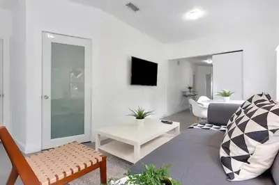 a living room with a couch and a table at Wynwood House With Pool, Hotub and Parking in Miami