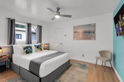 a bedroom with a bed and a desk and a window at Stunning 4BR Oasis with Pool, 14 minutes to the Ocean in Hollywood