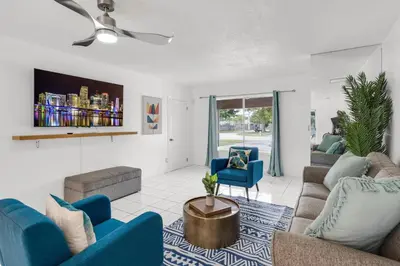 a living room with blue chairs and a couch at Stunning 4BR Oasis with Pool, 14 minutes to the Ocean in Hollywood