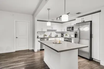 a kitchen with white appliances and a large island at Comfort and Convenience 2BR Unit with Free Parking in Miami