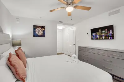 a bedroom with a white bed and a ceiling fan at Comfort and Convenience 2BR Unit with Free Parking in Miami