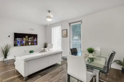 a living room with a white couch and a glass table at Comfort and Convenience 2BR Unit with Free Parking in Miami