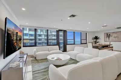a living room with white furniture and large windows at Luxury 2BD Penthouse with Beach Access and Resort Amenities PH6 in Miami Beach
