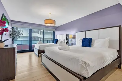 two beds in a hotel room with blue walls at 2 Bedroom Condo with Resort Amenities, Pool and Gym 618 in Miami Beach