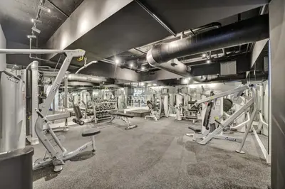 a gym with several treadmills and machines at 2 Bedroom Condo with Resort Amenities, Pool and Gym 618 in Miami Beach