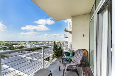 a balcony with a table and chairs and a view of a city at 1BR Miami Retreat with BBQ, Pool, & Skyline Views in Miami