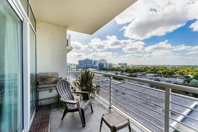 a balcony with a chair and a view of the city at 1BR Miami Retreat with BBQ, Pool, & Skyline Views in Miami