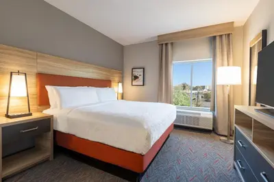 a hotel room with a bed and a window at Candlewood Suites Miami - Doral by IHG in Tamiami