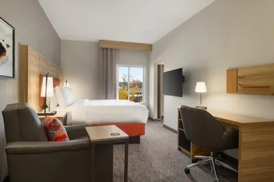 a hotel room with a bed and a desk at Candlewood Suites Miami - Doral by IHG in Tamiami
