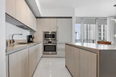 a kitchen with stainless steel appliances and a large window at Ventur Beachfront Luxe Condo - Lyfe Beach Resort in Hollywood