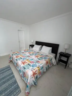 a bedroom with a bed with a colorful quilt on it at 1 bedroom with amazing ocean view in Hollywood