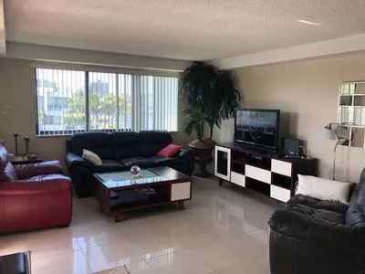a living room with couches and a flat screen tv at Golden Isles Suite 315 in Hallandale Beach