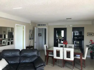 a living room with a couch and a table at Golden Isles Suite 315 in Hallandale Beach
