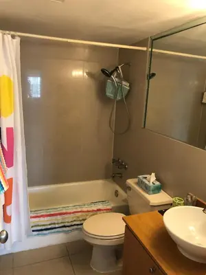a bathroom with a tub and a toilet and a sink at Golden Isles Suite 315 in Hallandale Beach