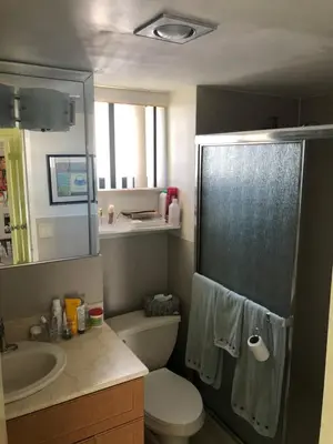 a bathroom with a toilet and a sink at Golden Isles Suite 315 in Hallandale Beach