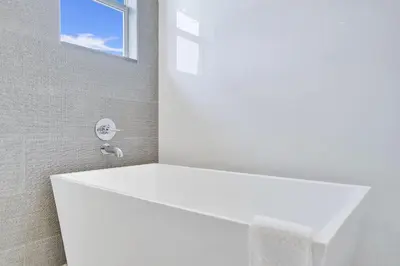 a white bath tub in a bathroom with a window at The Secret Garden - Stunning Luxurious Villa in Fort Lauderdale in Fort Lauderdale